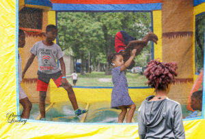 A group of kids playing in a bounce house.