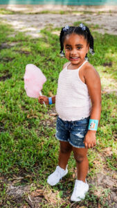 A girl holding cotton candy.