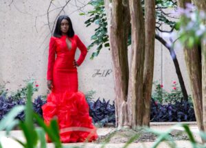 Recipient of Project Prom 2017 in a long, red gown